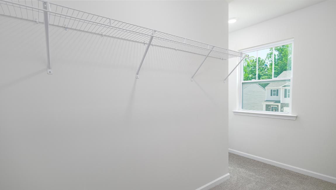 Primary walk in closet with window