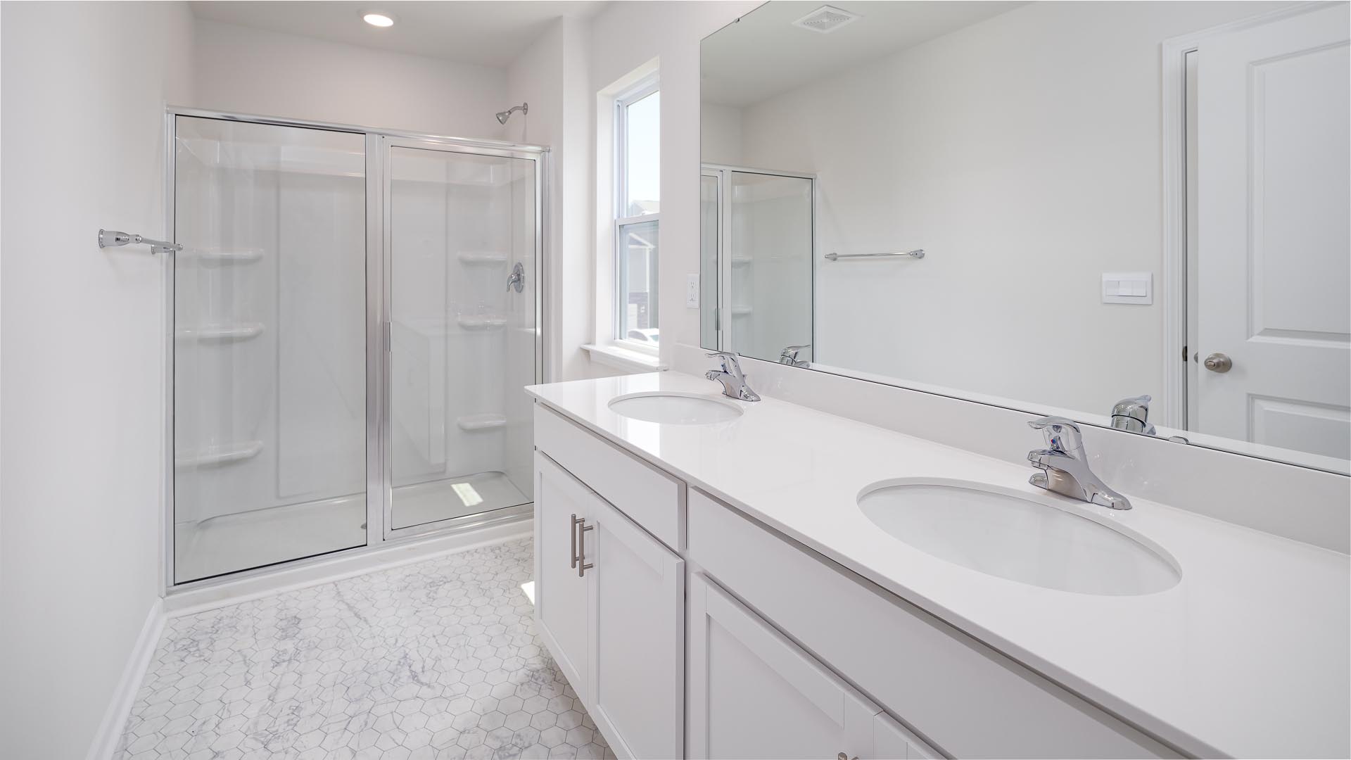 Primary bathroom with dual vanity and walk in shower