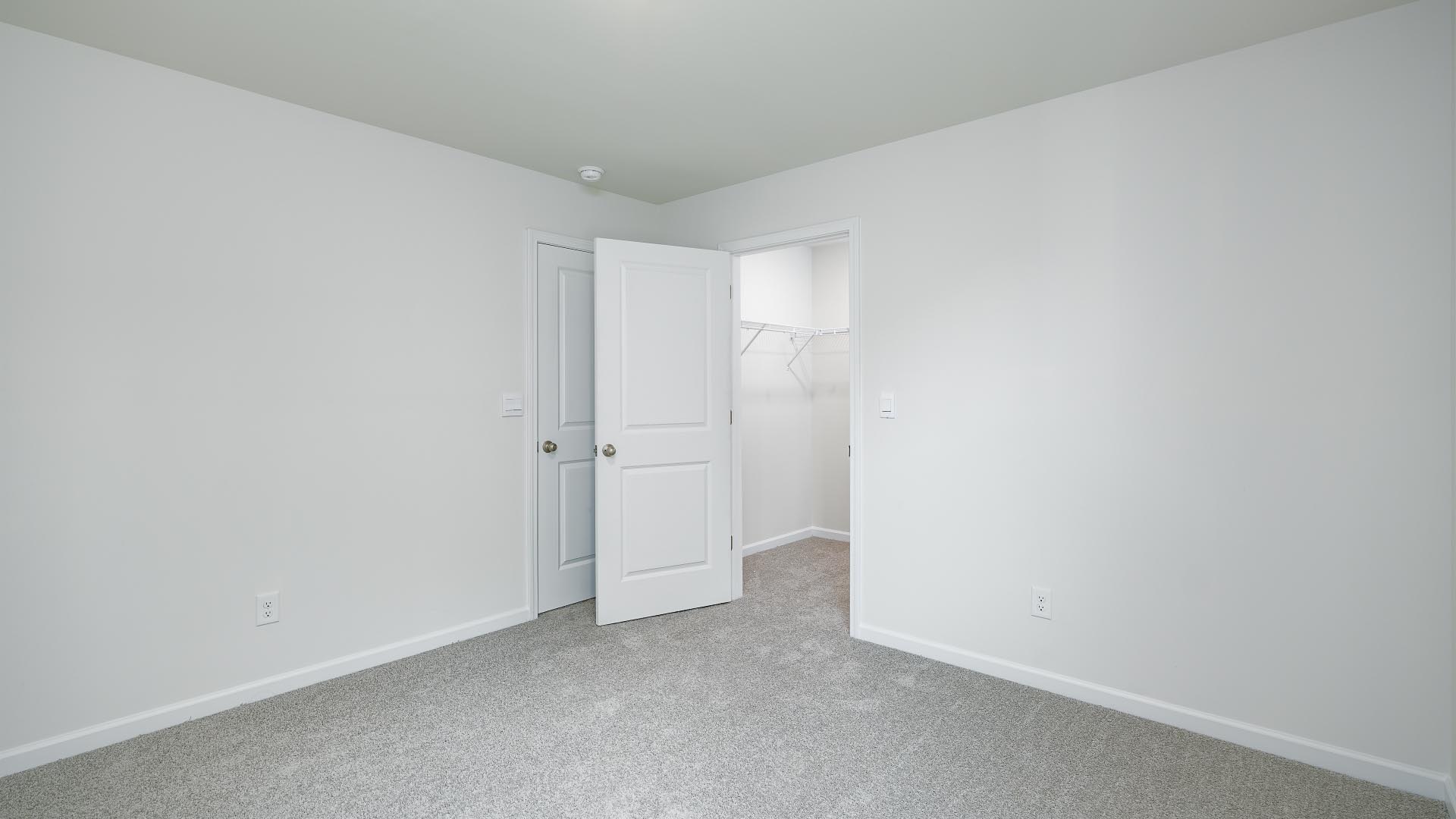 Carpeted bedroom with closet
