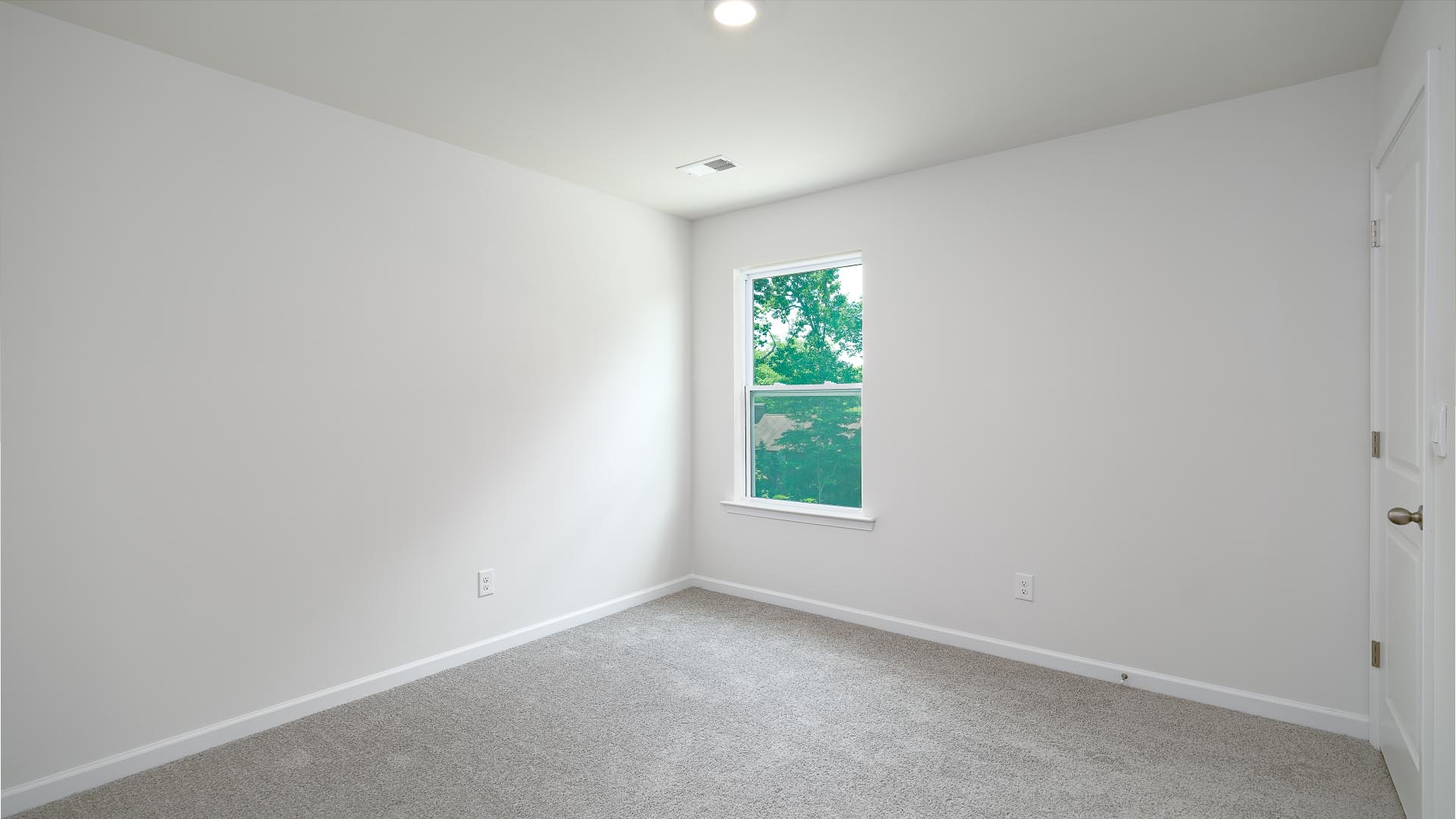 Carpeted bedroom with window