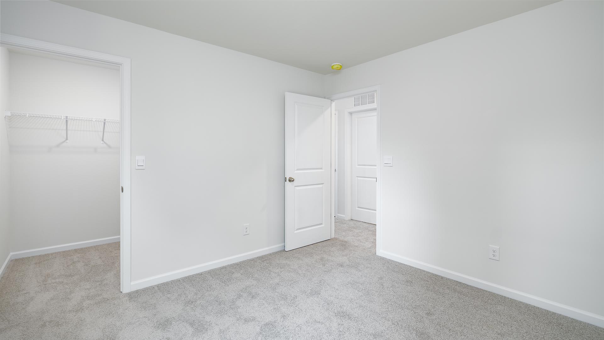 Carpeted bedroom with closet