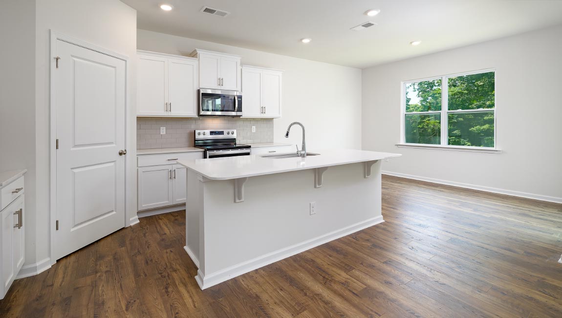 Open kitchen with large island and stainless steel appliacnes