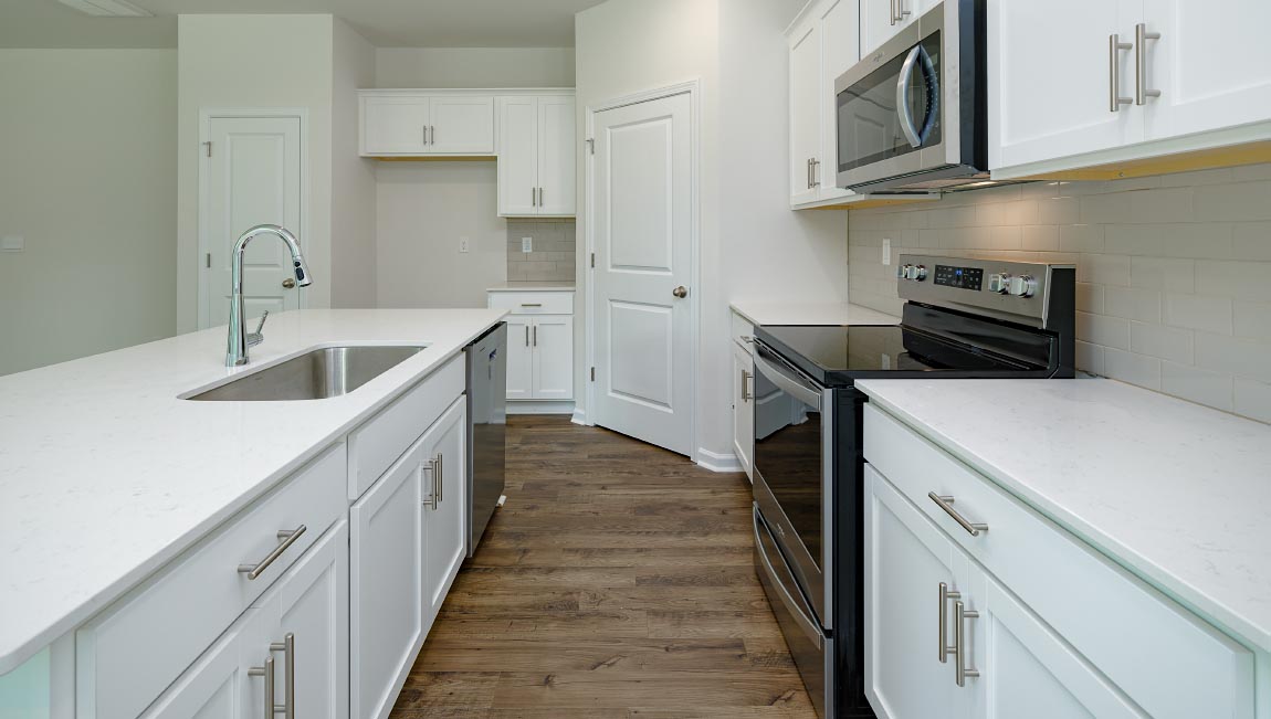 Open kitchen with large island and stainless steel appliacnes