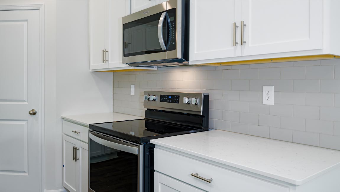 Open kitchen with large island and stainless steel appliacnes