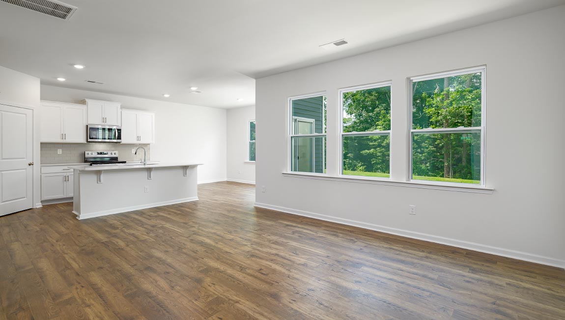 Open living area with large windows and electric fireplace