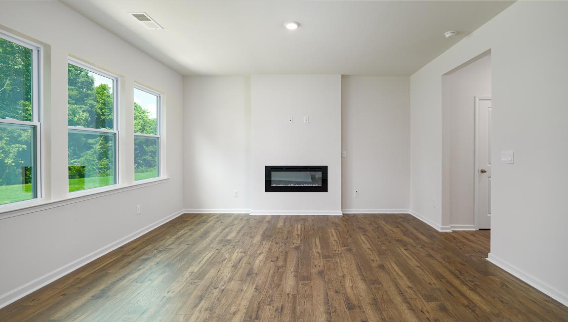 Open living area with large windows and electric fireplace