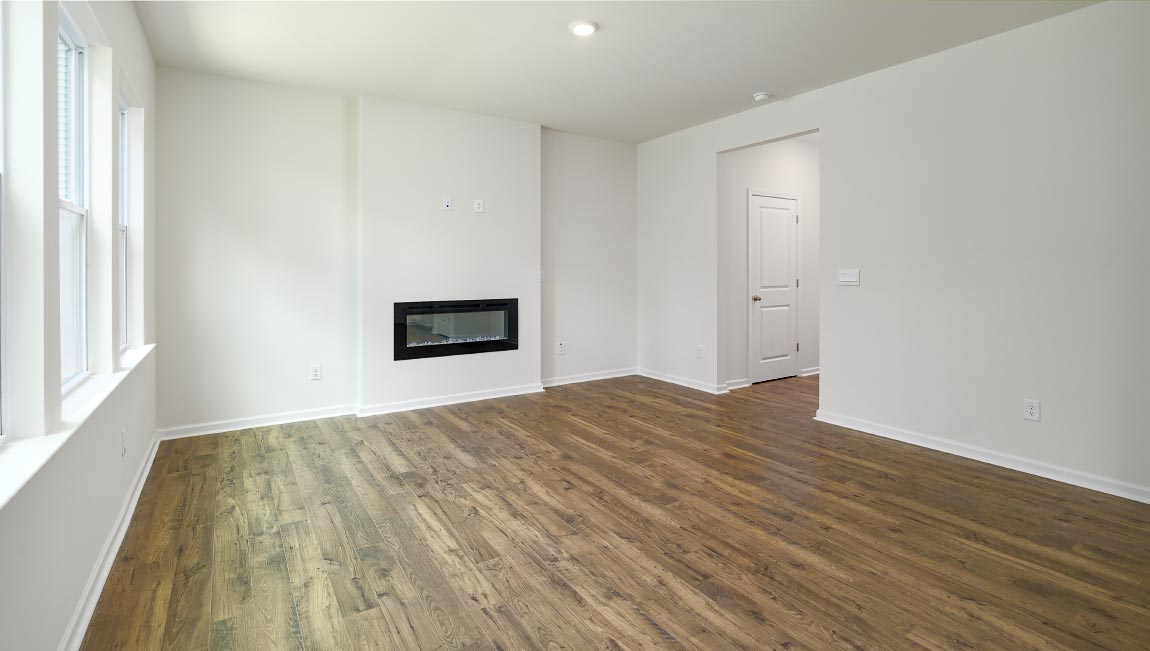 Open living area with large windows and electric fireplace