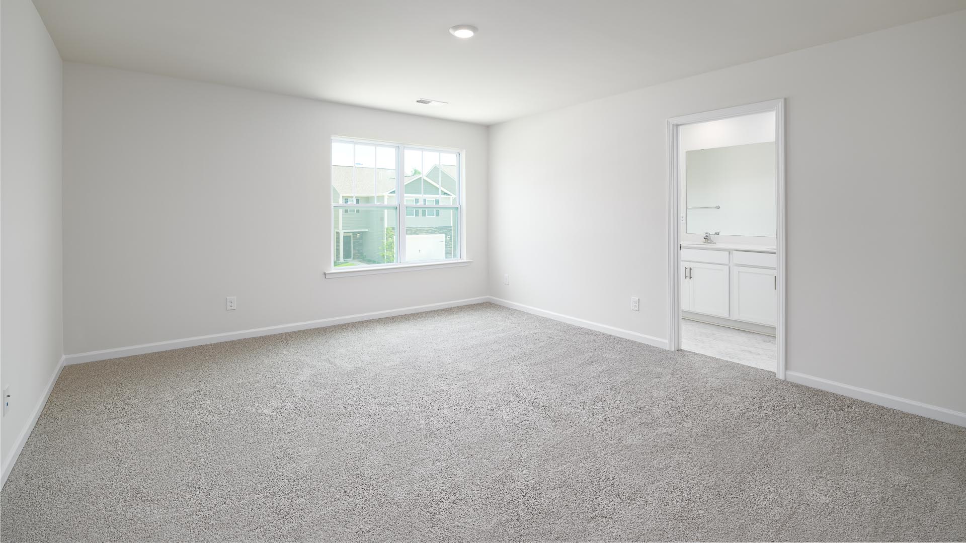 Carpeted upstairs loft with window