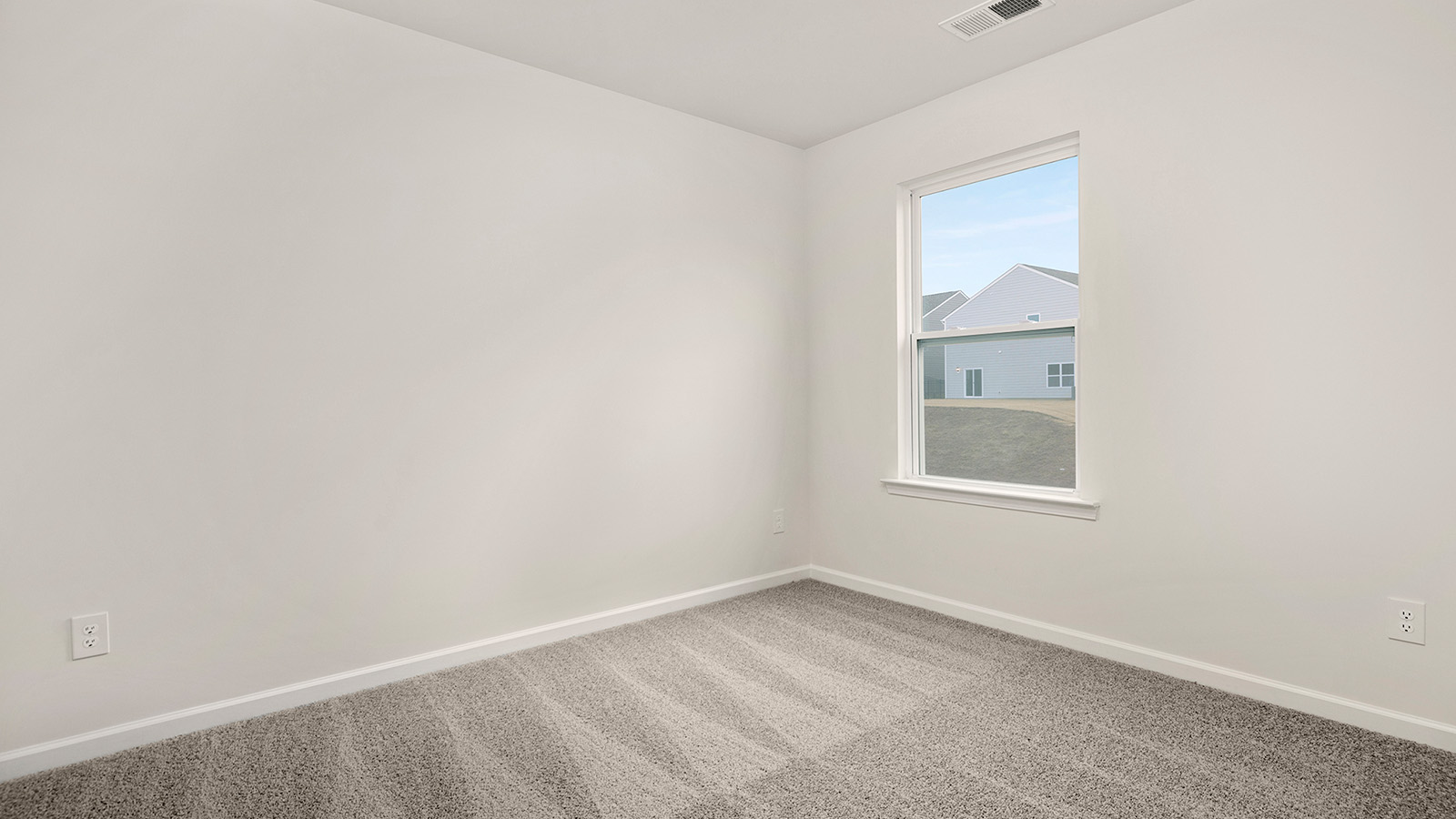 Carpeted bedroom with large windows