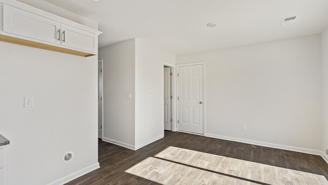 Open kitchen with white cabinets