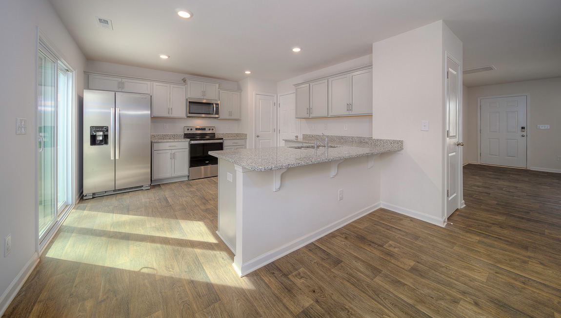 Kitchen with white cabinets, granite countertops and stainless steel appliances