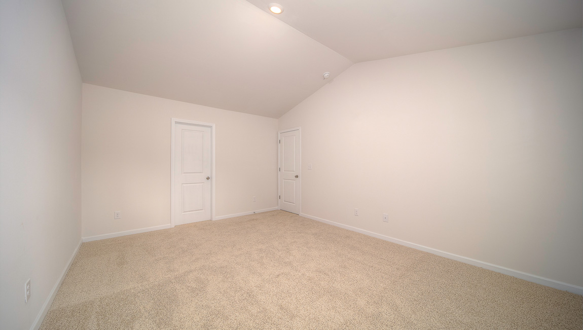 Primary bedroom walk in closet with small window