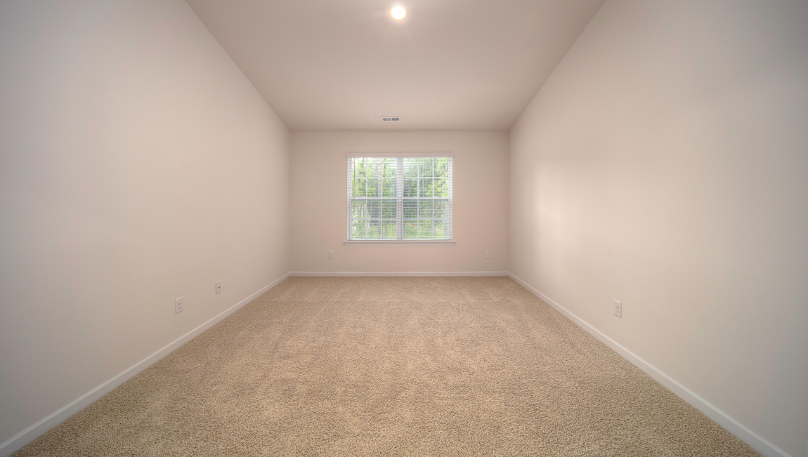 Primary bedroom walk in closet with small window