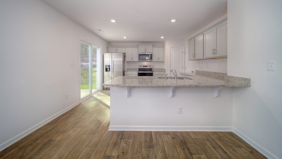 Kitchen with white cabinets, granite countertops and stainless steel appliances