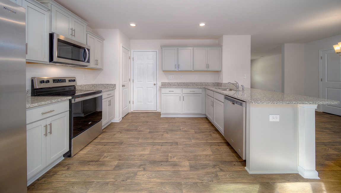 Kitchen with white cabinets, granite countertops and stainless steel appliances