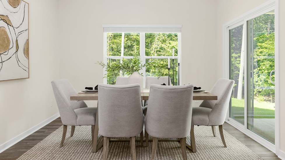 Dining room with wood floors, large window and sliding glass back door