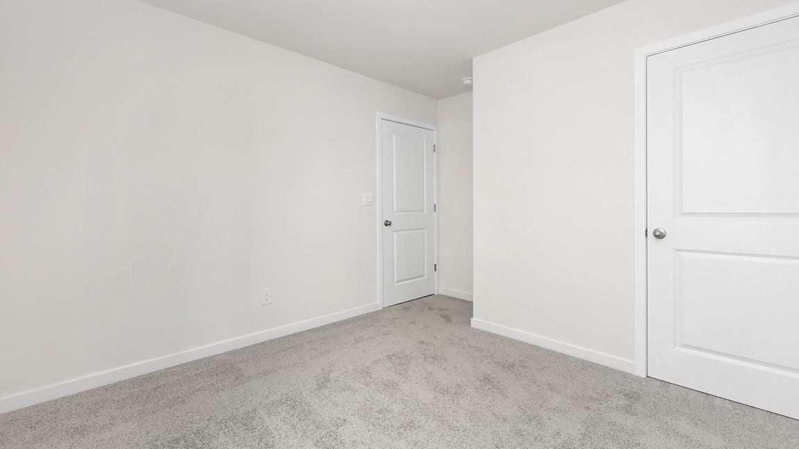 Carpeted bedroom with large window