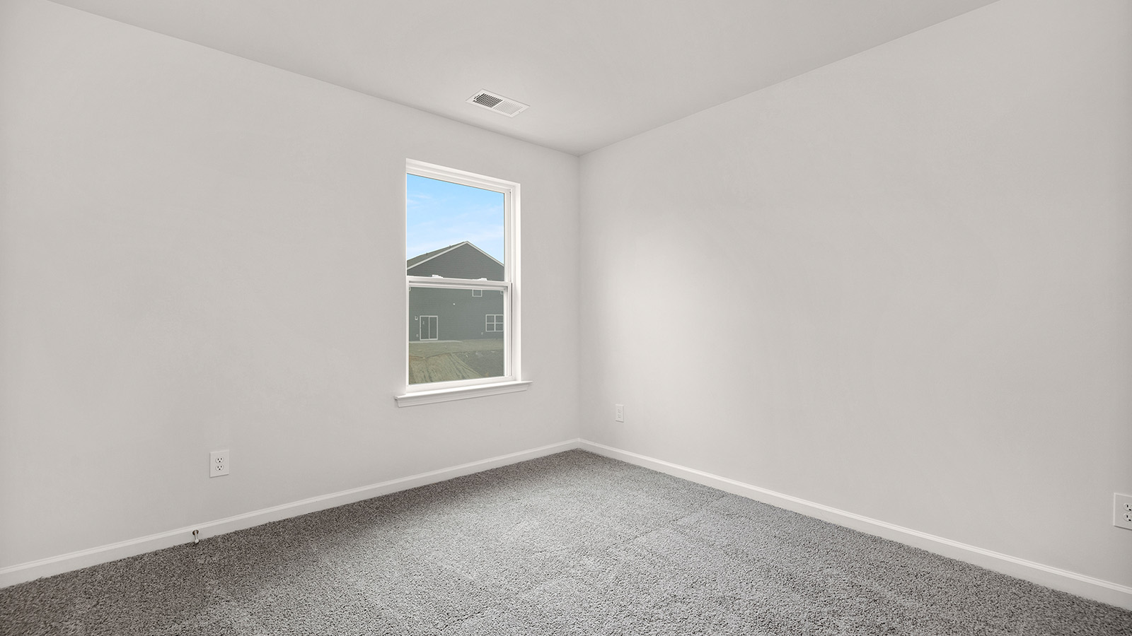 carpeted bedroom with small window and closet