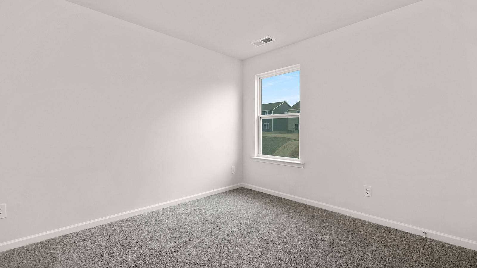 carpeted bedroom with small window and closet