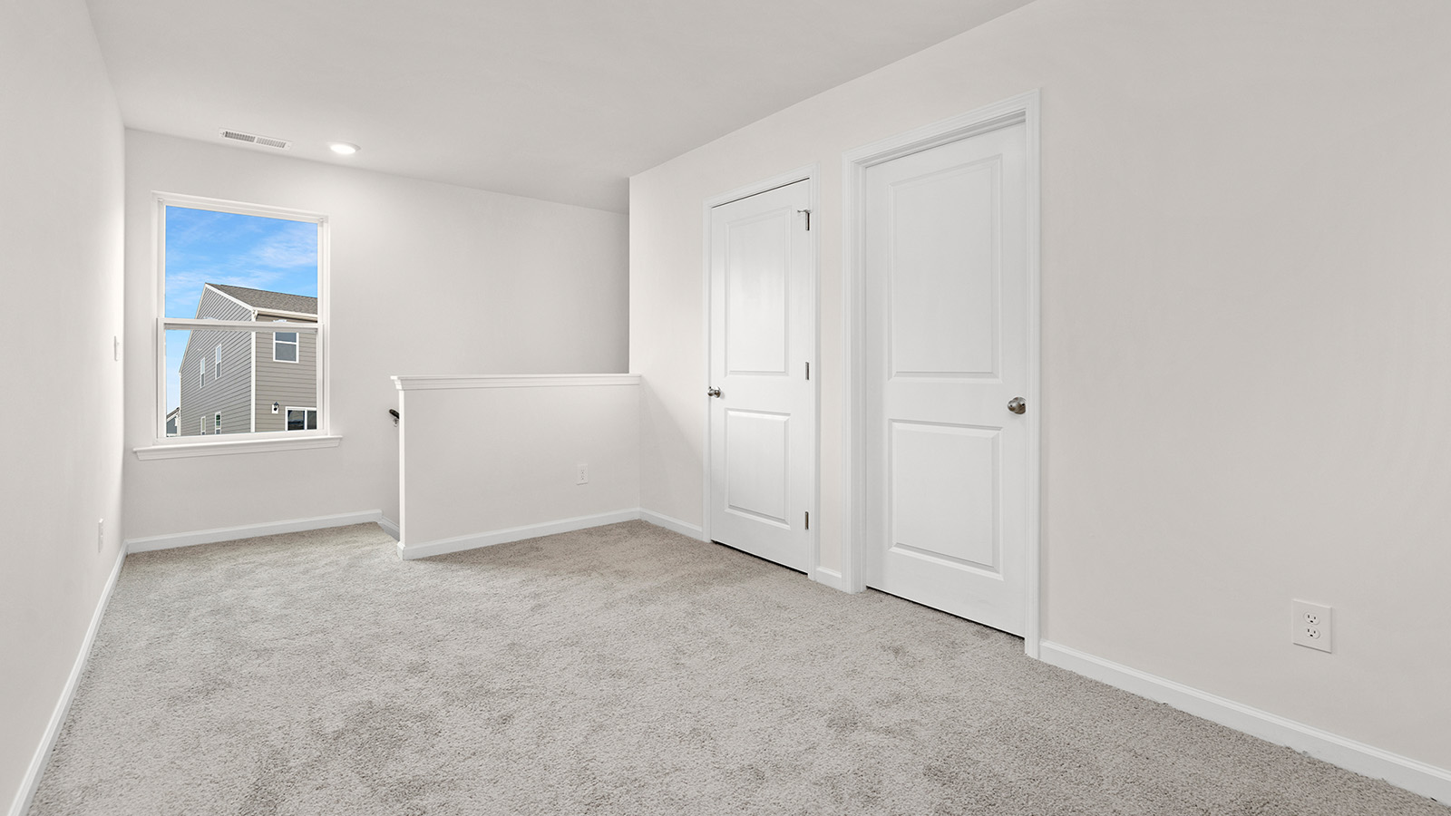 Loft with carpet and large window