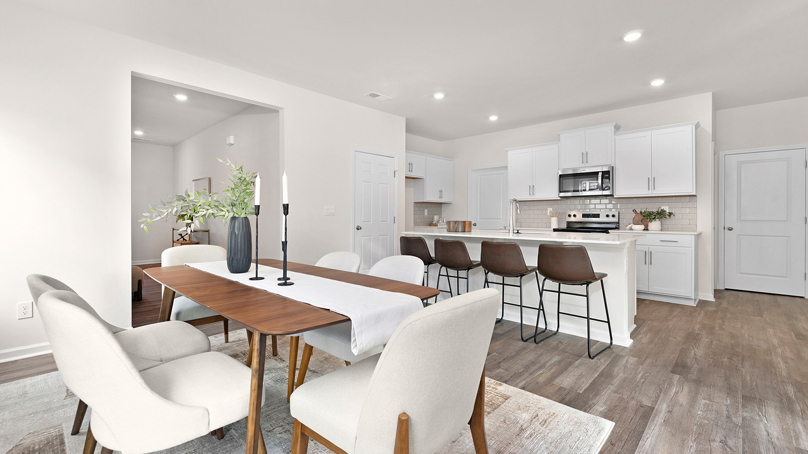 Dining space beside kitchen and living room with large window