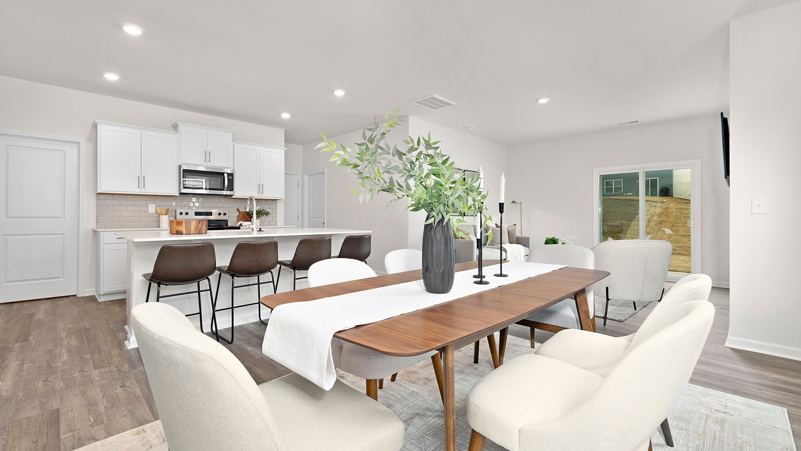 Dining space beside kitchen and living room with large window