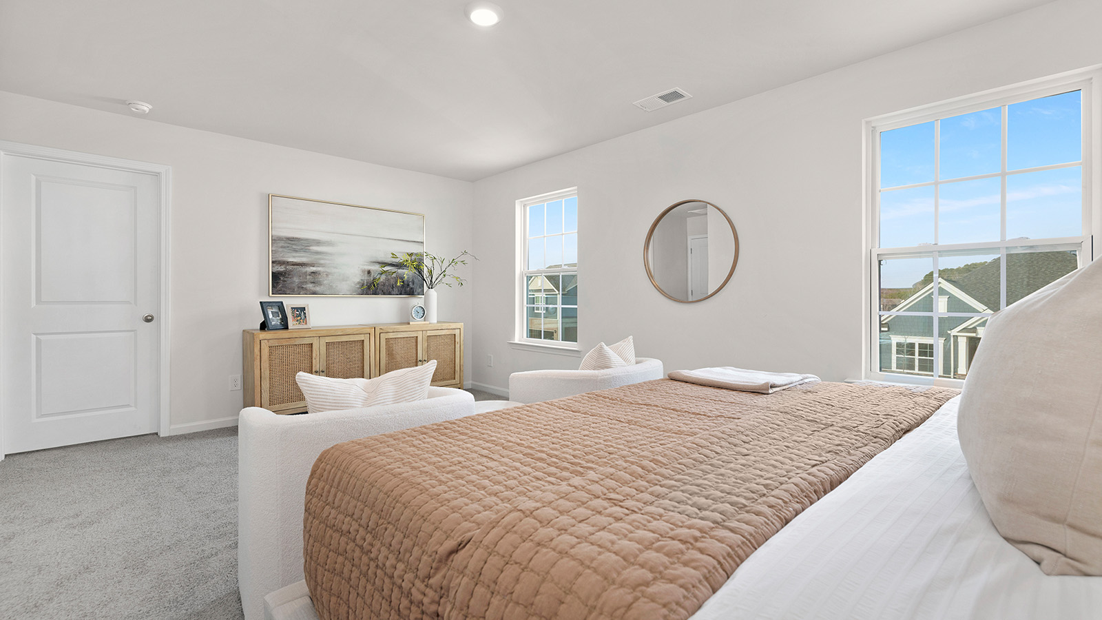 Primary bedroom with two large windows