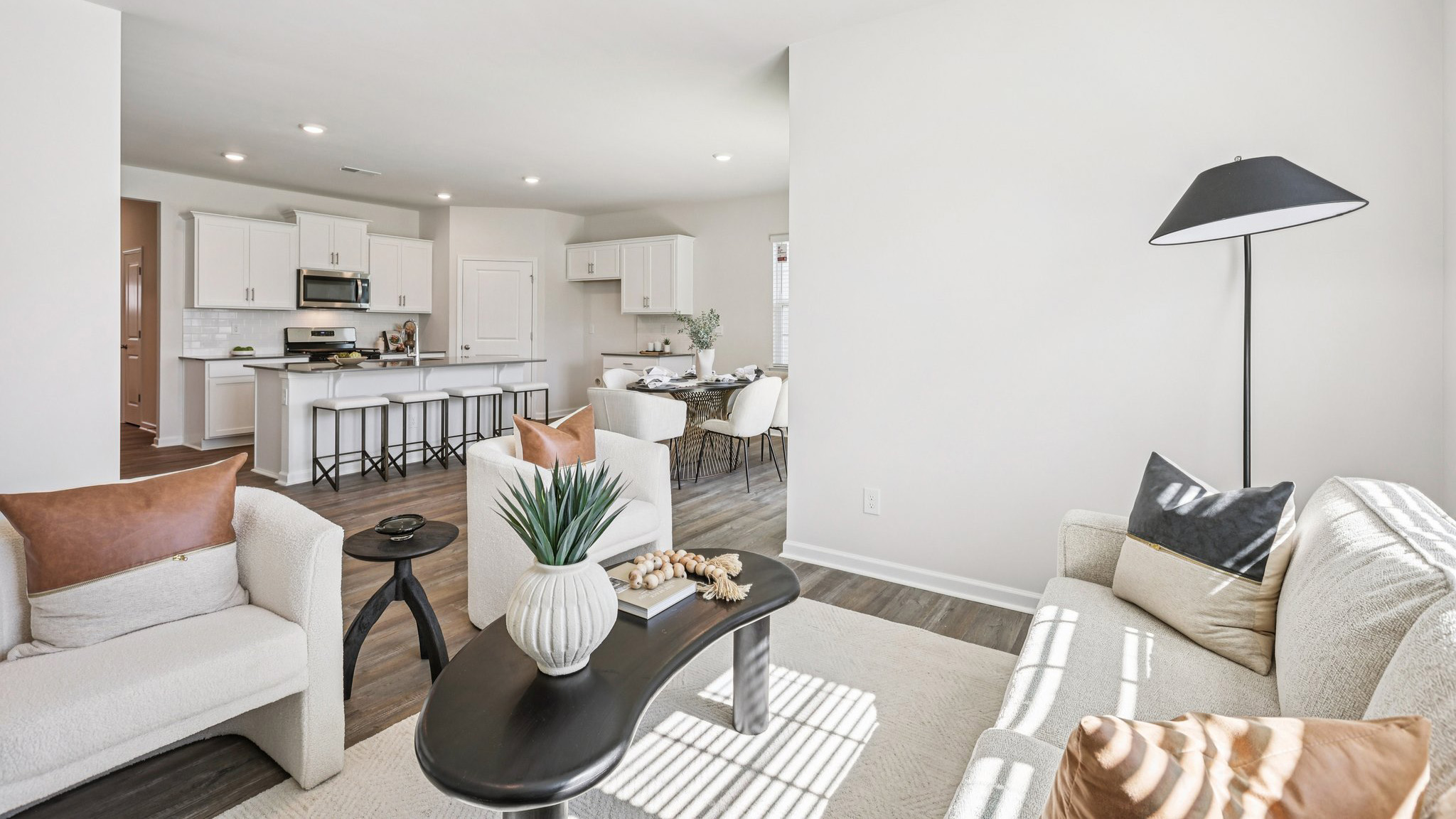Full living room view with kitchen in background