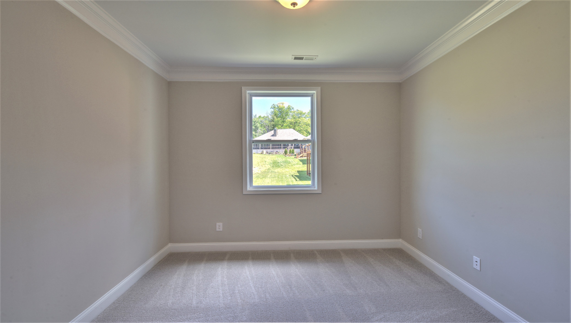 Carpeted bedroom with window