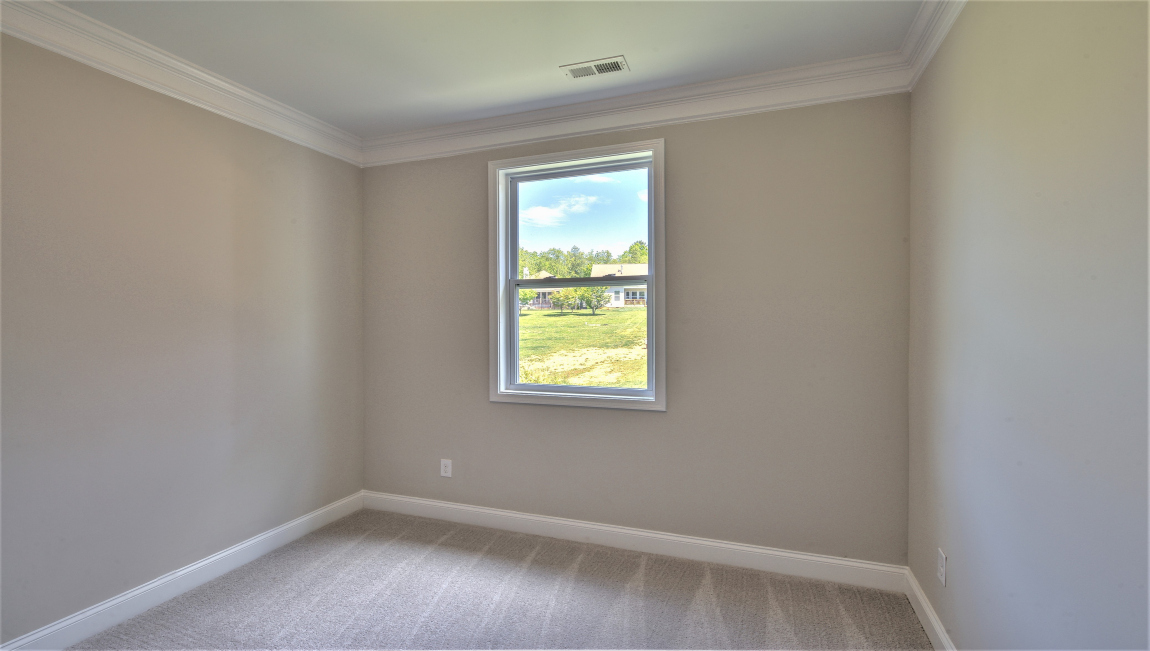 Carpeted bedroom with window