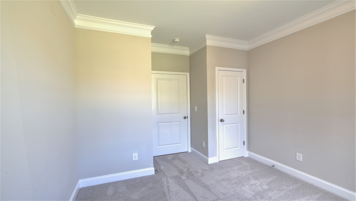 Carpeted bedroom with door