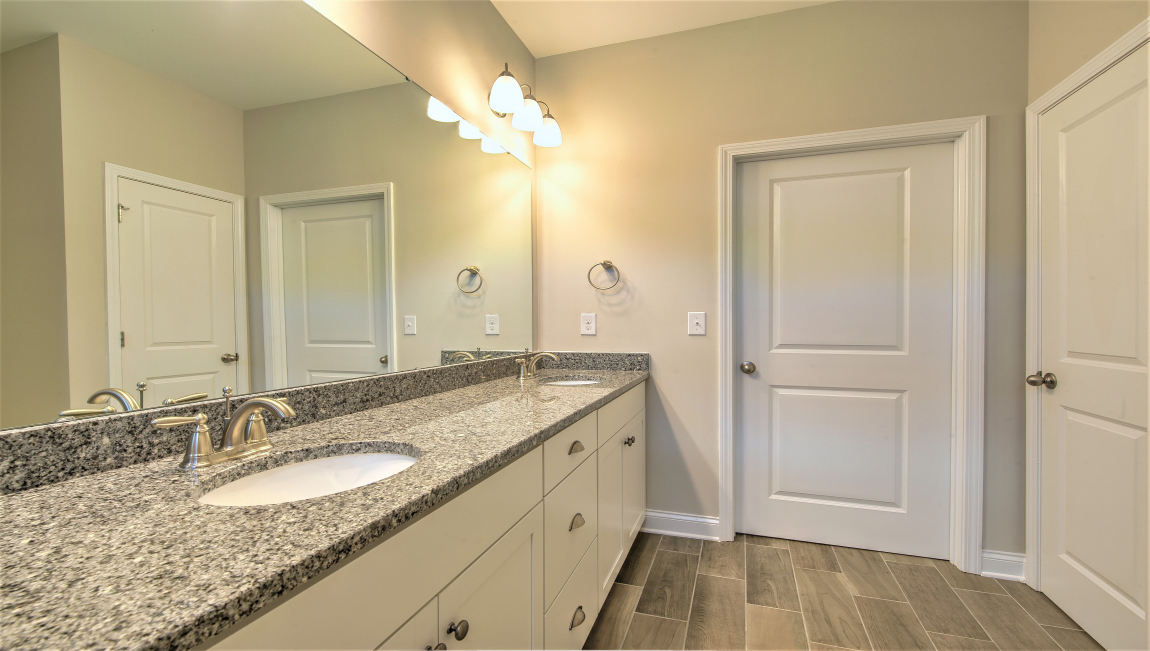 Primary bathroom with double vanity and walk in shower