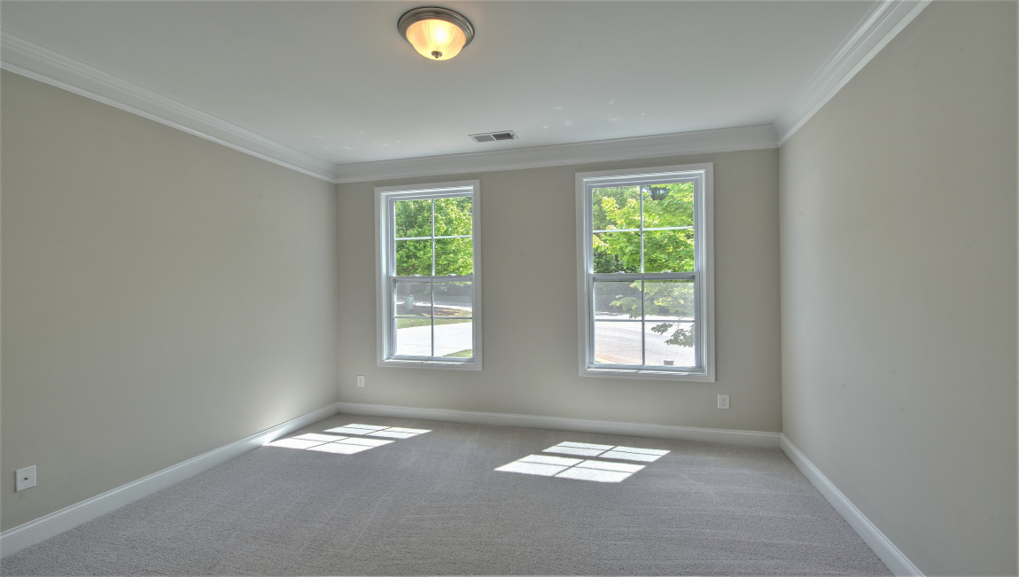 Carpeted bedroom with windows
