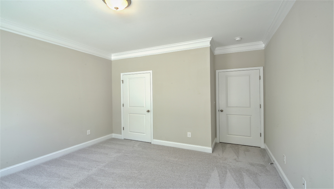 Carpeted bedroom with windows