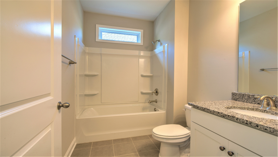 Bathroom with double vanity and bathtub