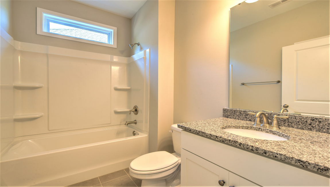 Bathroom with double vanity and bathtub