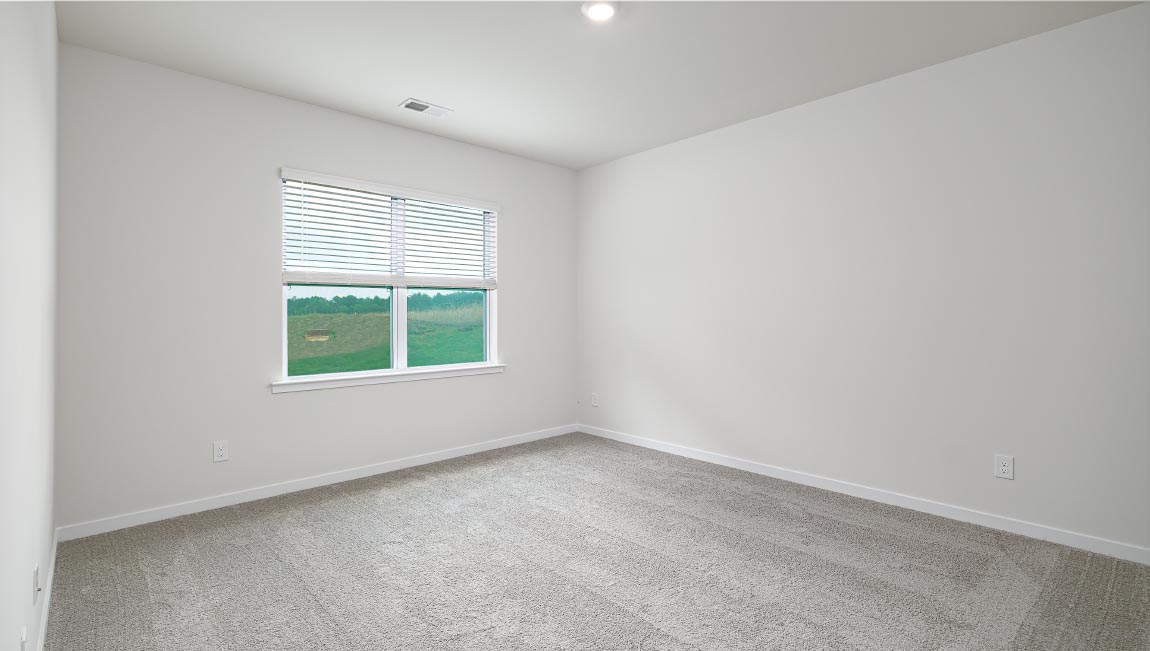 Carpeted bedroom with large window