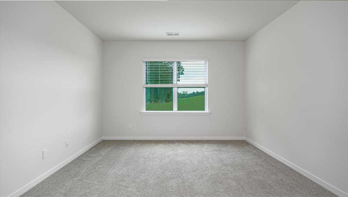 Carpeted bedroom with large window