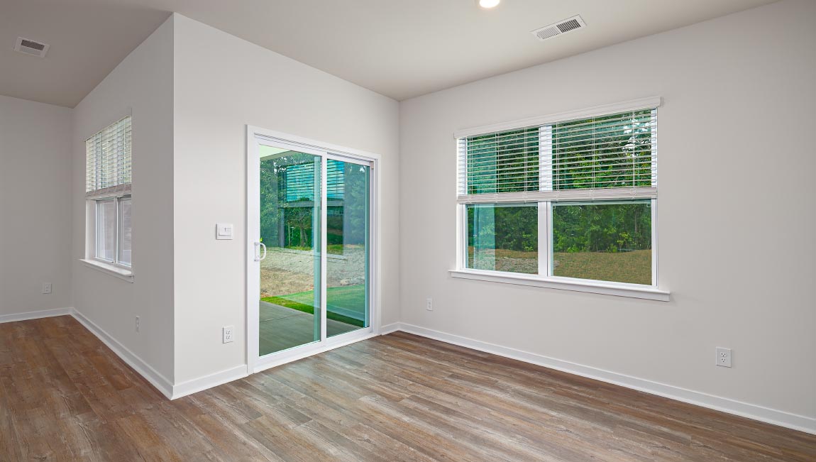 Dining room with wood floors, large window and sliding glass back door