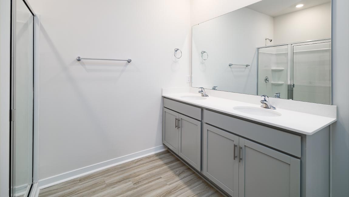 Primary bathroom with dual vanity and walk in shower