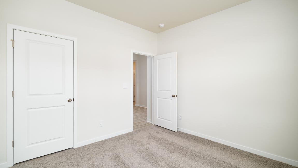 Carpeted bedroom with closet