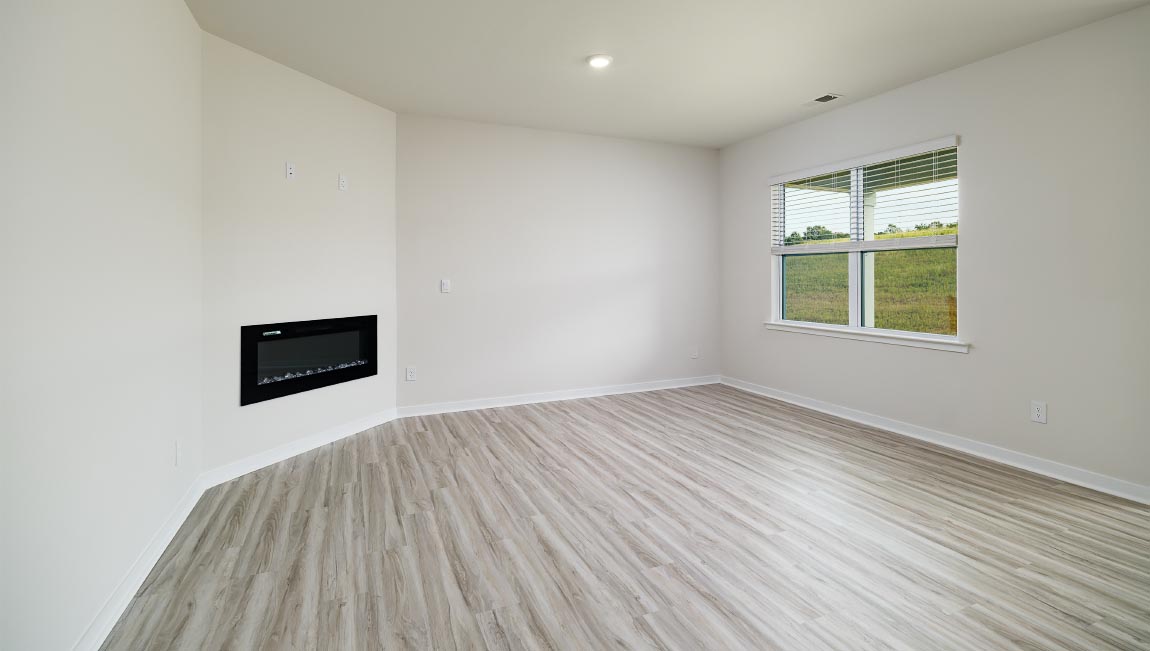 Living area with electric fireplace and windows