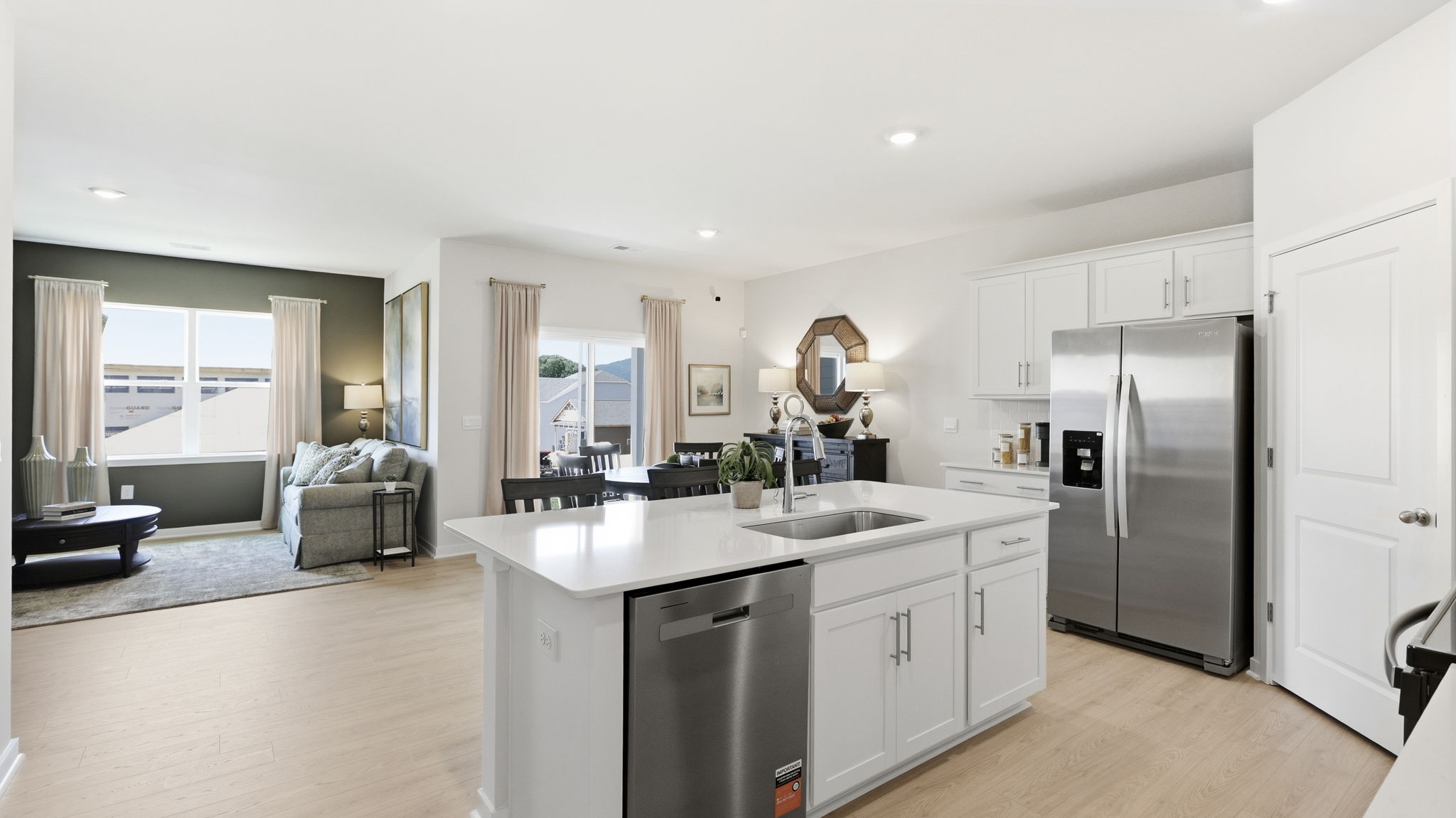 Open kitchen area with large island and stainless steel appliances