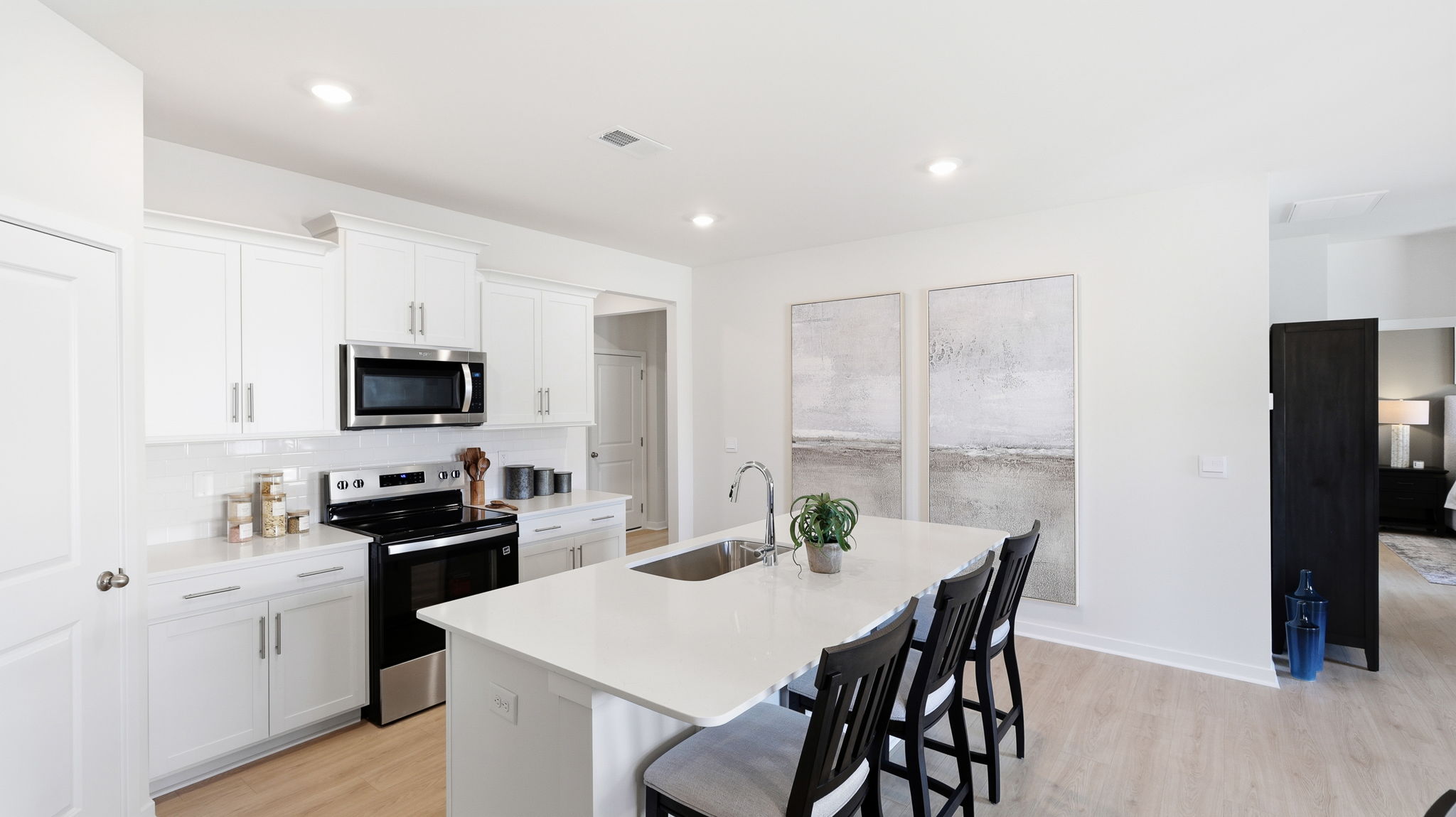 Open kitchen area with large island and stainless steel appliances