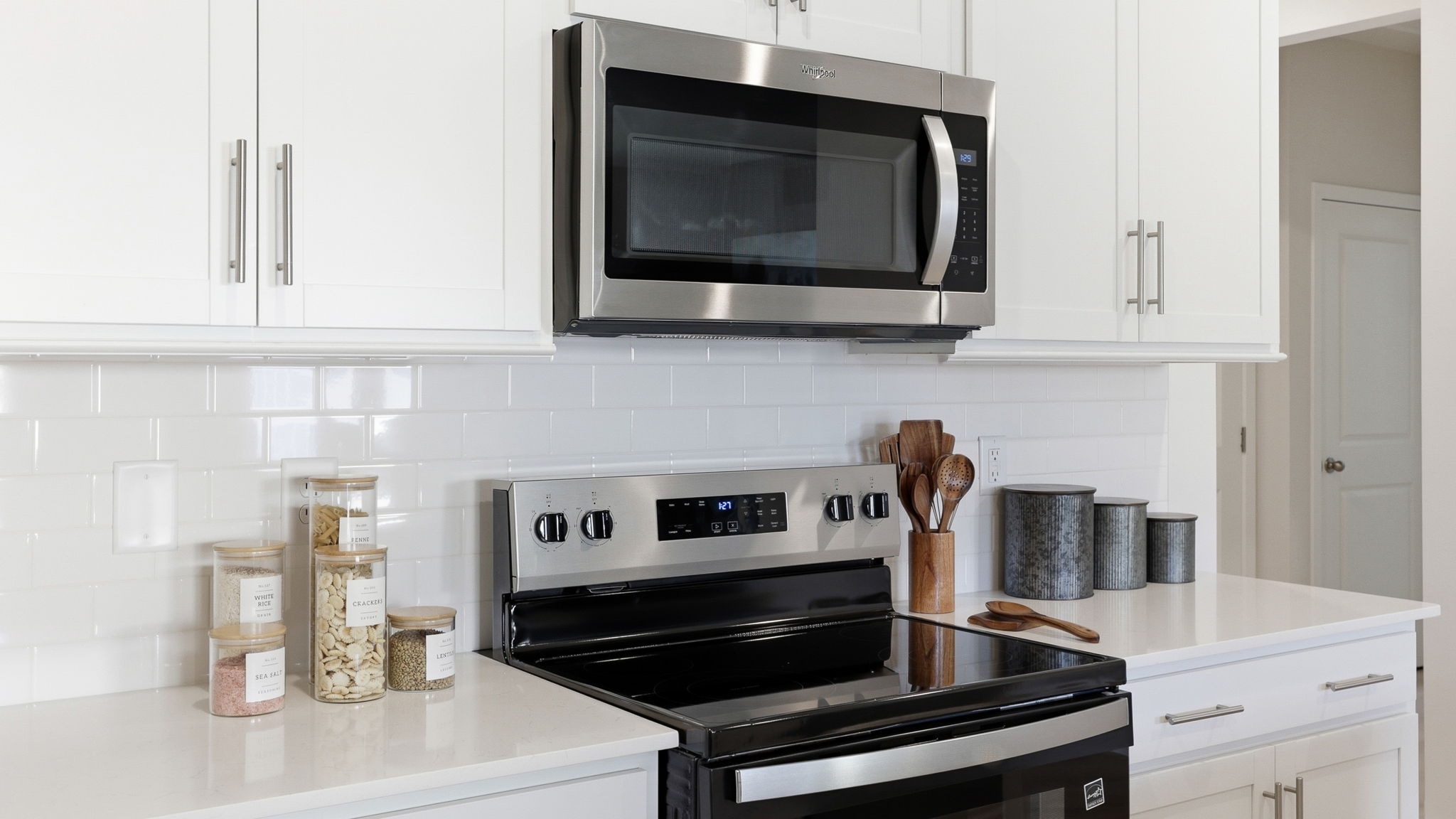 Open kitchen area with large island and stainless steel appliances