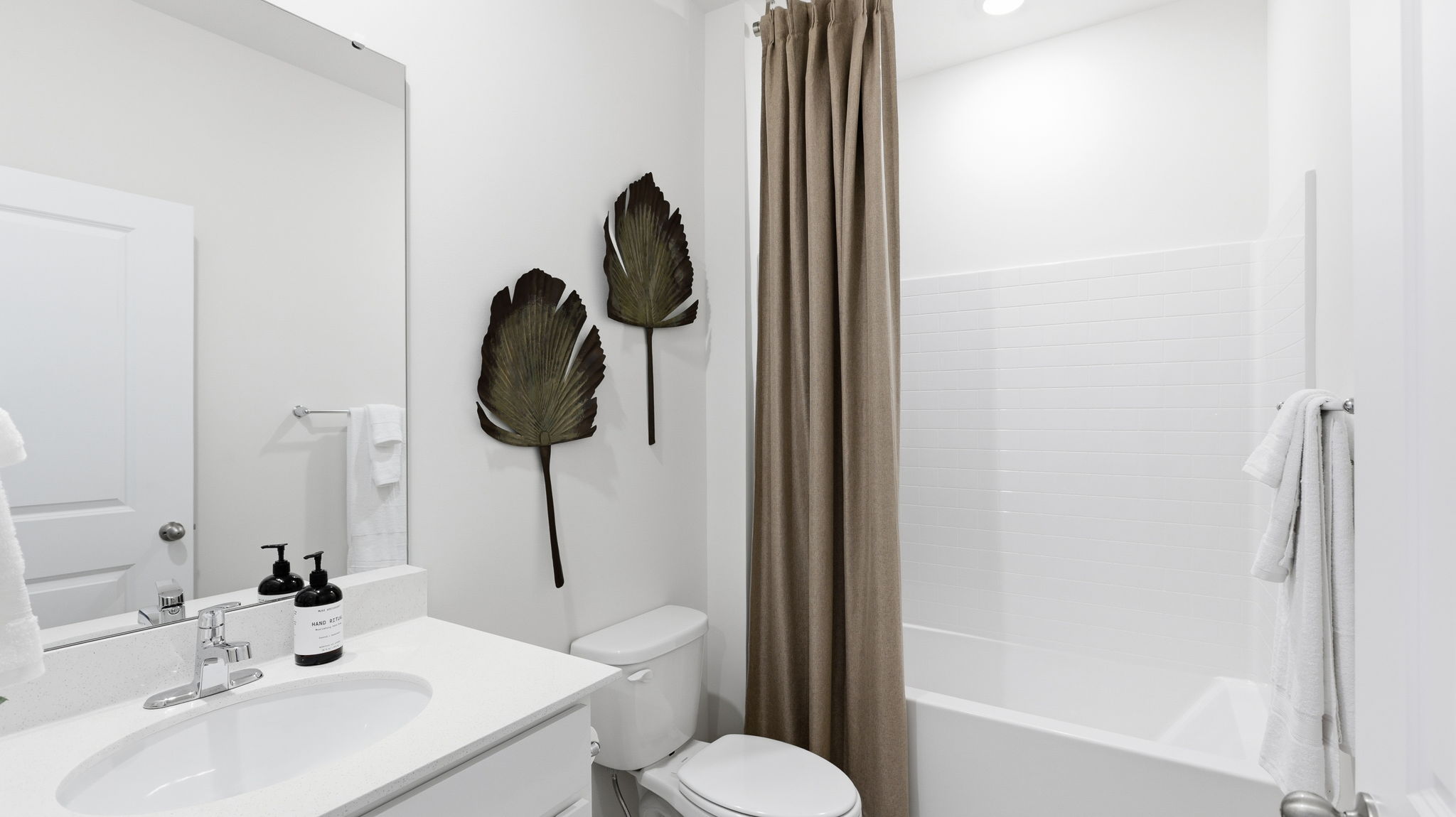 Bathroom with single vanity and bathtub