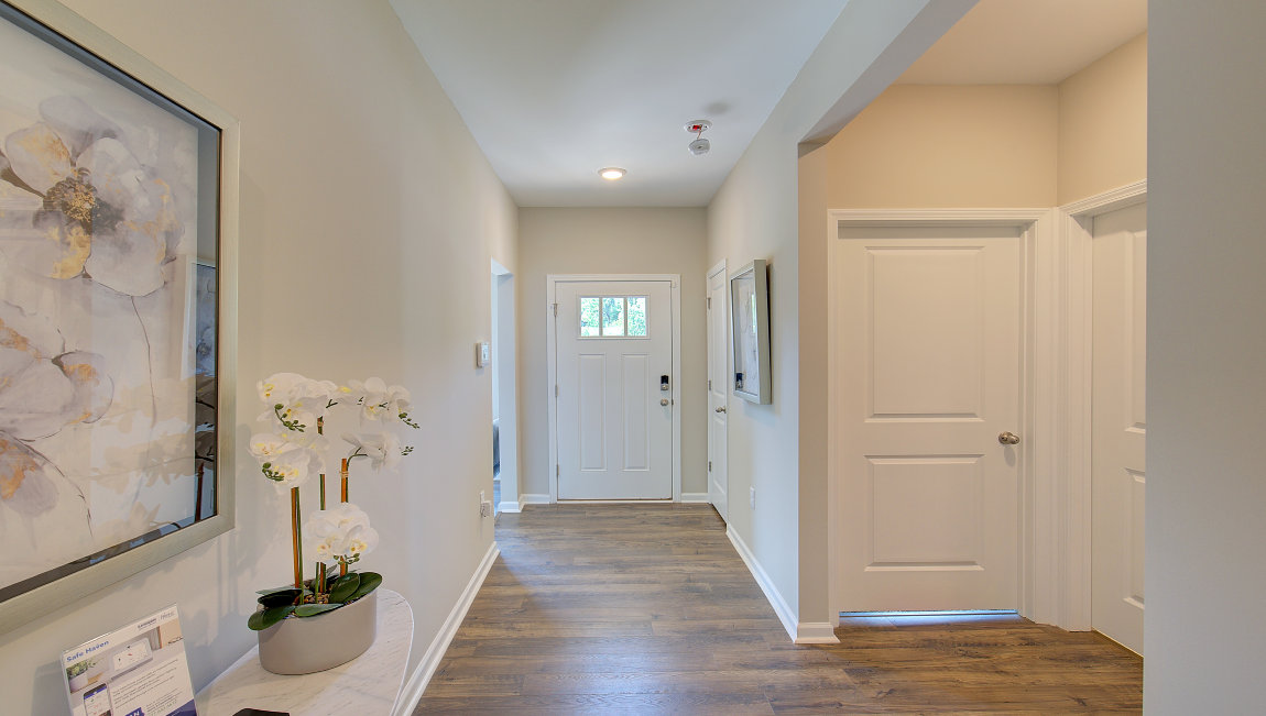 Welcoming foyer with wood floors
