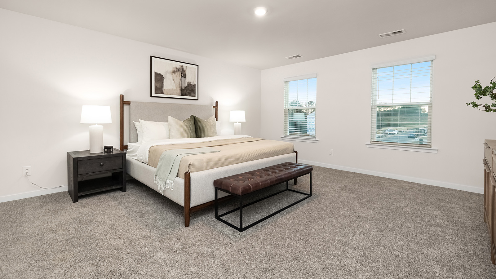primary bedroom with carpet and two large windows