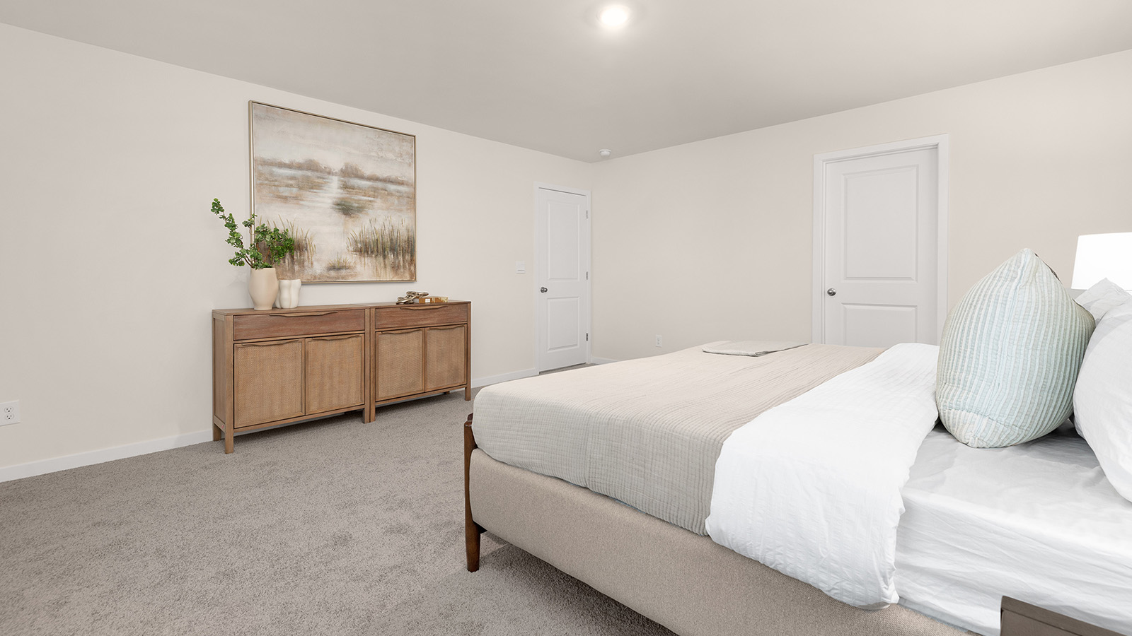 primary bedroom with carpet and two large windows