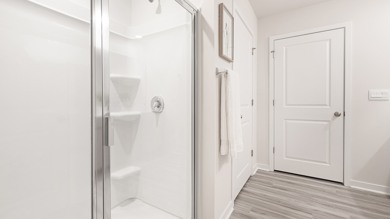 primary bathroom with double sinks, white counters and cabinets
